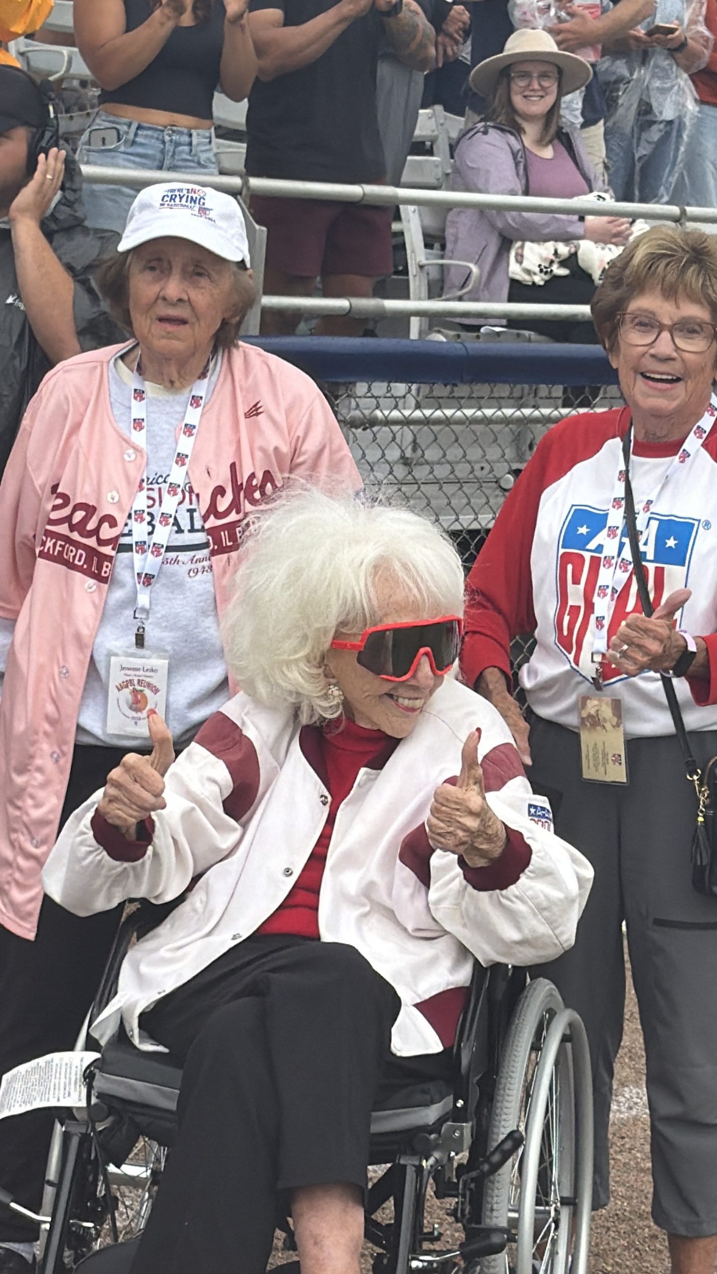 Jeneane DesCombes and Gloria Rodgers escort Maybelle Blair onto the field before the inaugural Women’s Professional Baseball League game at Robin Roberts Stadium in Springfield, Illinois.